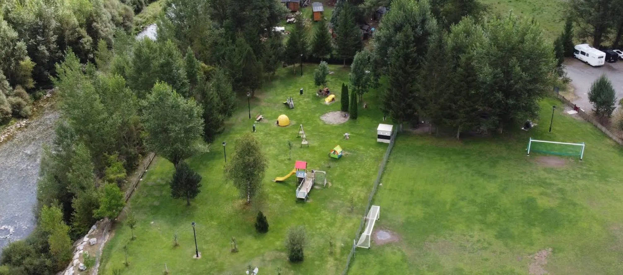 Vista aérea del Parque de Villanova, con zona de juegos infantiles, campo de fútbol y el río al lado